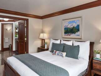 Step into luxury with this beautifully appointed bedroom, featuring a cozy king-sized bed and elegant decor.