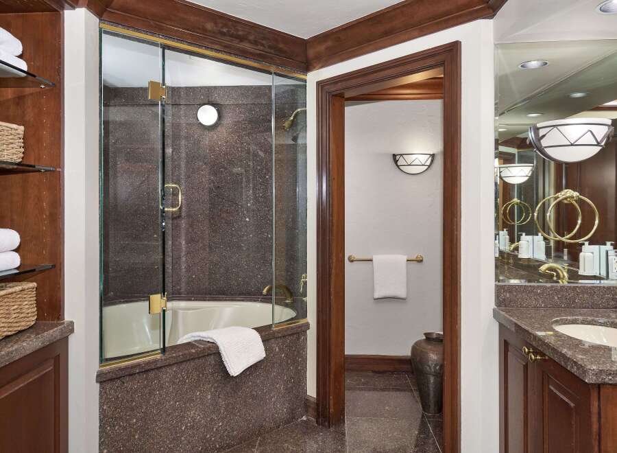 Step into luxury with this stunning bathroom featuring a sleek glass-enclosed shower and elegant granite countertops.