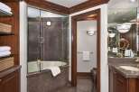 Step into luxury with this stunning bathroom featuring a sleek glass-enclosed shower and elegant granite countertops.