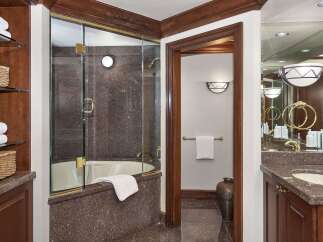 Step into luxury with this stunning bathroom featuring a sleek glass-enclosed shower and elegant granite countertops.