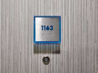 This property features a modern and stylish design, evident in the sleek door and contemporary door number.