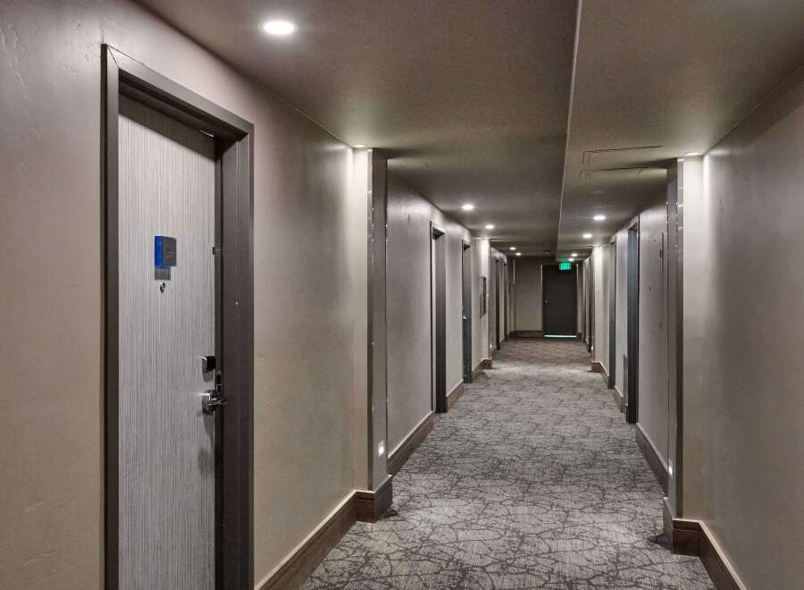 Step into a well-lit hotel hallway, showcasing a modern and inviting atmosphere.