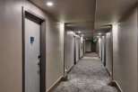 Step into a well-lit hotel hallway, showcasing a modern and inviting atmosphere.