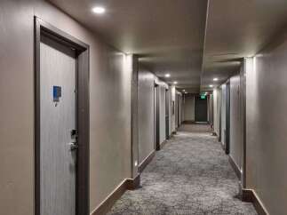 Step into a well-lit hotel hallway, showcasing a modern and inviting atmosphere.