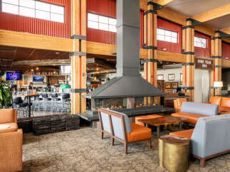 Step into the inviting ambiance of this stunning property, featuring a cozy fireplace and stylish seating areas.