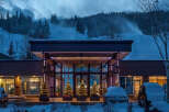 Experience the ultimate winter getaway at this stunning property! Featuring a grand entrance, the building is surrounded by snow-covered landscapes, and decorated with Christmas trees.