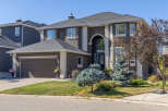 This stunning property boasts a modern design with a dark exterior and elegant white trim.