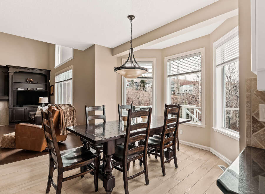 This stunning dining room features a dark wood dining table and chairs, perfect for hosting dinner parties.
