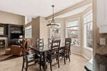 This stunning dining room features a dark wood dining table and chairs, perfect for hosting dinner parties.