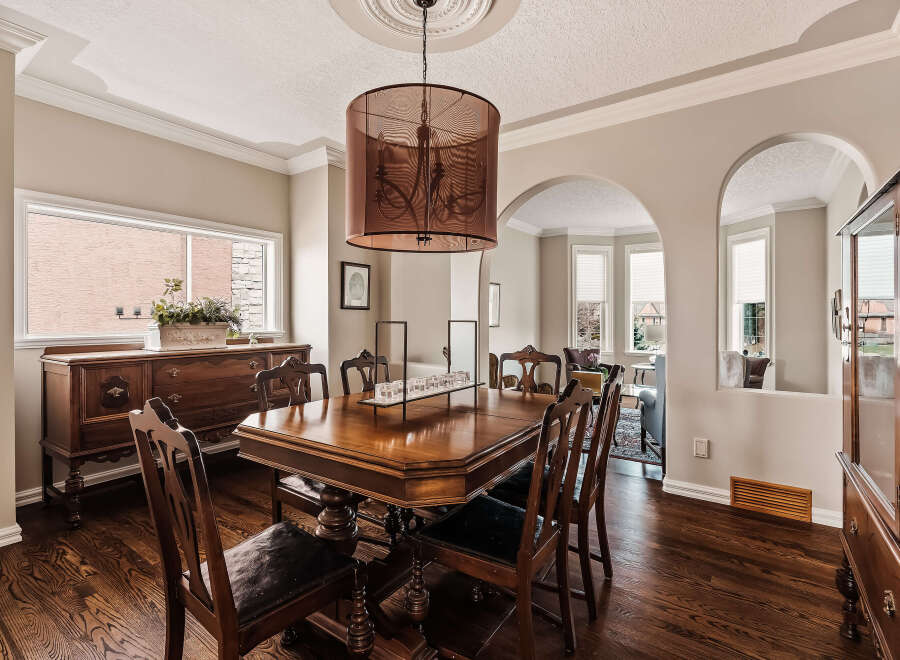 Step into elegance with this stunning dining room, featuring a beautiful wooden table and chairs, perfect for hosting memorable gatherings.