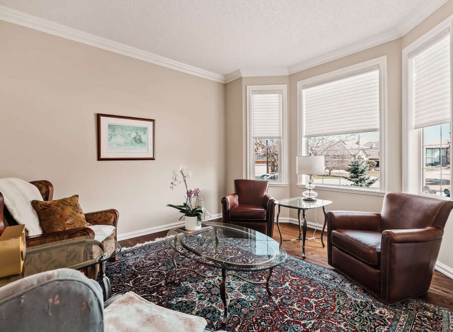Step into luxury with this stunning living room, featuring exquisite leather armchairs and a captivating glass coffee table.
