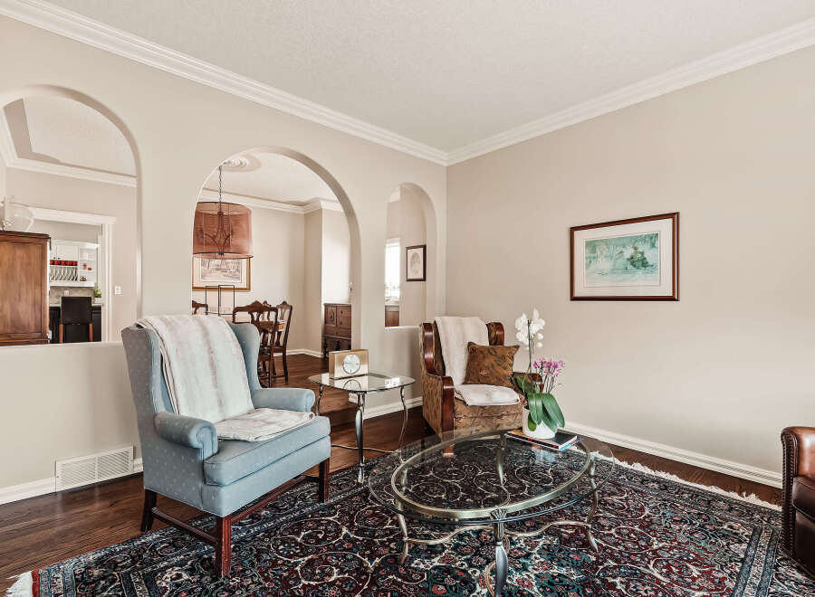 Step into this inviting living space, featuring elegant archways and a cozy ambiance.