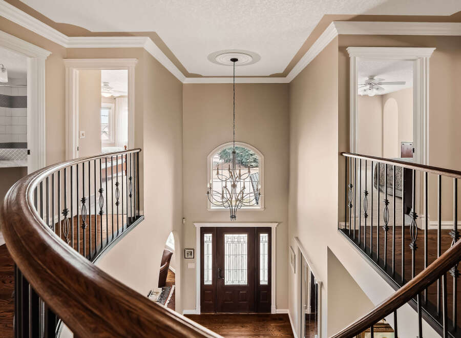 Step into luxury with this stunning entryway, showcasing a grand staircase and elegant chandelier.