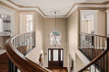 Step into luxury with this stunning entryway, showcasing a grand staircase and elegant chandelier.