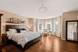 Step into this elegant bedroom, featuring a spacious layout and abundant natural light.