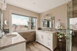 Step into luxury with this stunning bathroom featuring a spacious vanity and a large window offering breathtaking views.