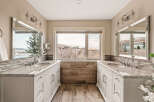 This stunning bathroom features dual vanities with elegant marble countertops and ample storage.