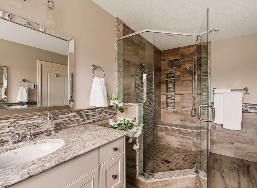 Step into luxury with this stunning bathroom featuring a spacious walk-in shower with a glass enclosure.