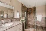 Step into luxury with this stunning bathroom featuring a spacious walk-in shower with a glass enclosure.
