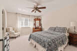 This inviting bedroom boasts a cozy atmosphere with its plush carpet and soft lighting.