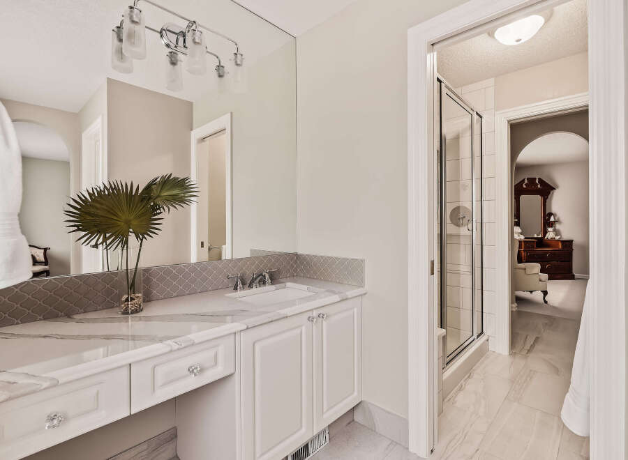 Step into luxury with this stunning bathroom! Featuring a sleek vanity, elegant lighting, and a spacious shower, this space is designed for relaxation and style.