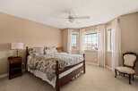 Step into this inviting bedroom, featuring a comfortable bed with stylish bedding and ample natural light.