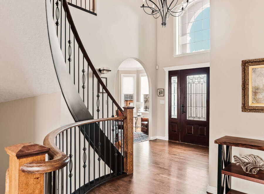 Step into luxury with this stunning home featuring a grand staircase and elegant hardwood floors.
