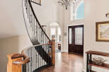 Step into luxury with this stunning home featuring a grand staircase and elegant hardwood floors.