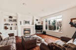 This stunning living room boasts a cozy fireplace, perfect for chilly evenings, and built-in shelving to showcase your favorite decor.