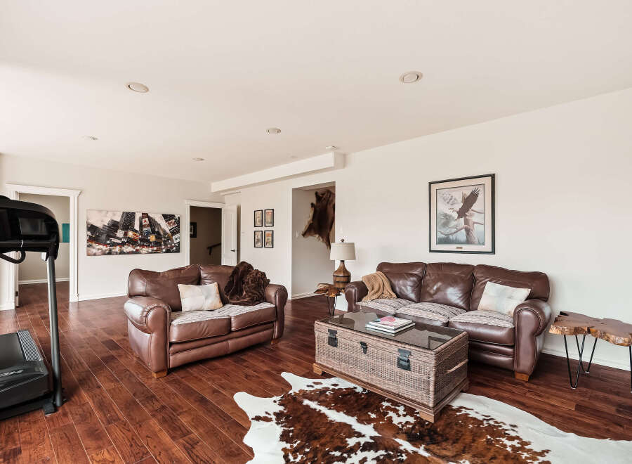 This stunning living room boasts a warm and inviting atmosphere, perfect for relaxation and entertaining.