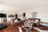 This stunning living room boasts a warm and inviting atmosphere, perfect for relaxation and entertaining.