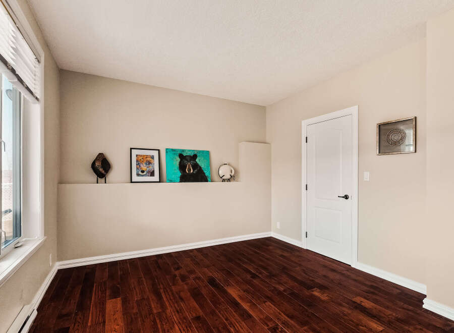Step into this inviting space, featuring rich hardwood floors and neutral walls that create a warm and welcoming atmosphere.
