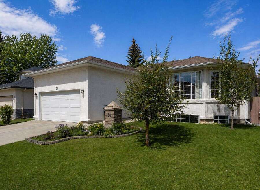 This stunning property boasts a beautiful exterior with a well-maintained lawn and lush landscaping.