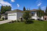 This stunning property boasts a beautiful exterior with a well-maintained lawn and lush landscaping.