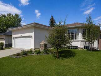 This stunning property boasts a beautiful exterior with a well-maintained lawn and lush landscaping.