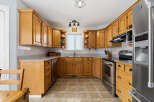 Step into this inviting kitchen, featuring warm wooden cabinetry that exudes timeless charm.