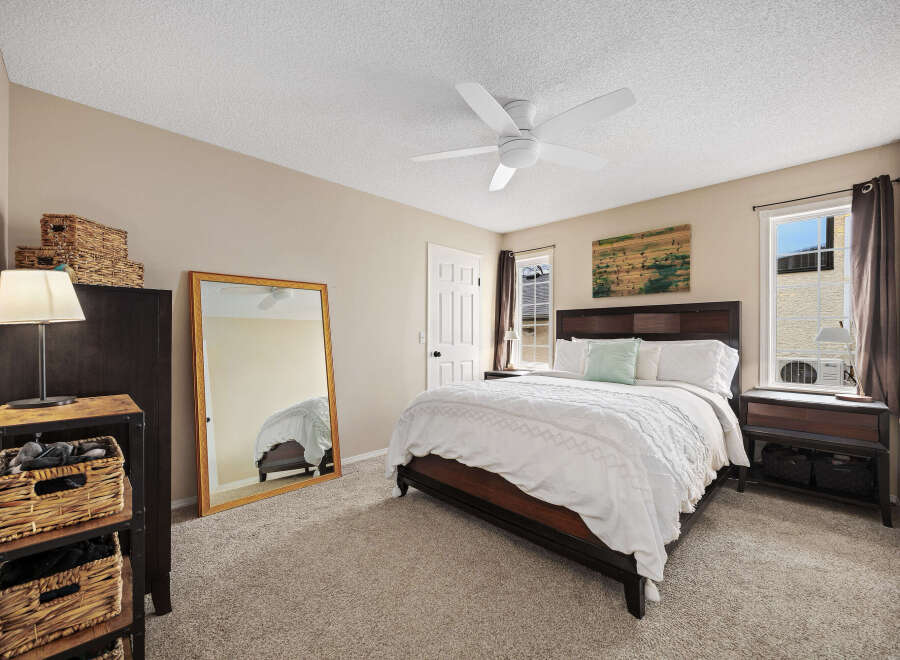 This inviting bedroom features a comfortable bed with a stylish headboard, perfect for relaxation.