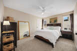 This inviting bedroom features a comfortable bed with a stylish headboard, perfect for relaxation.