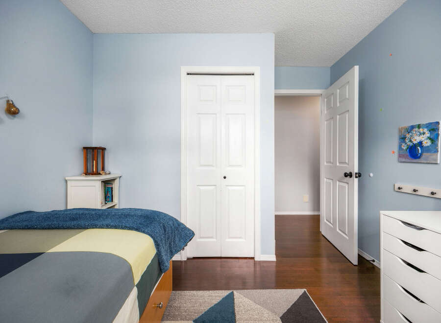 Step into this inviting bedroom, featuring a soothing light blue color scheme that creates a serene atmosphere.