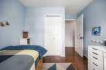 Step into this inviting bedroom, featuring a soothing light blue color scheme that creates a serene atmosphere.