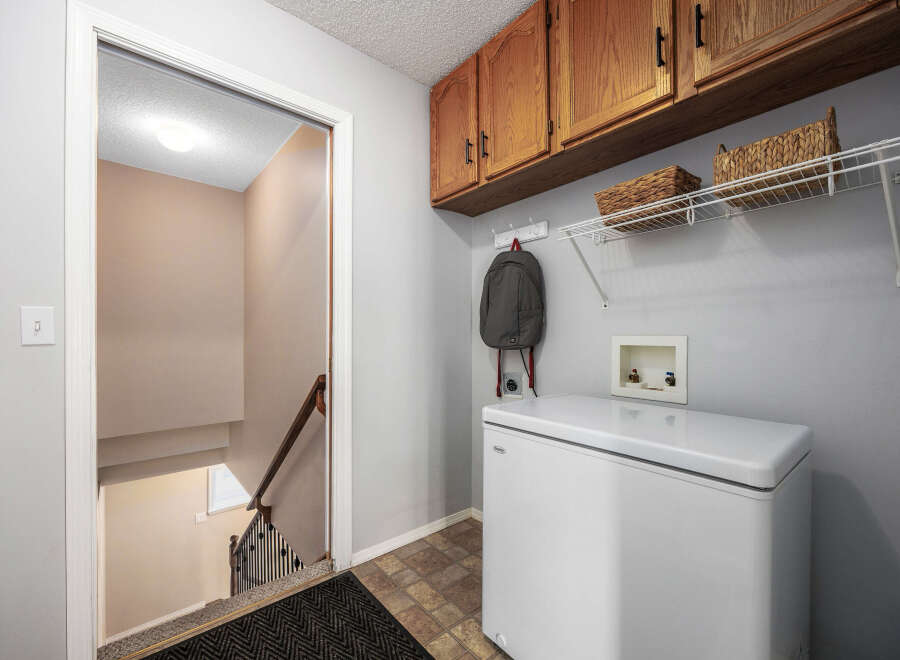 This inviting laundry room features a practical layout with ample storage solutions.