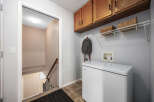 This inviting laundry room features a practical layout with ample storage solutions.