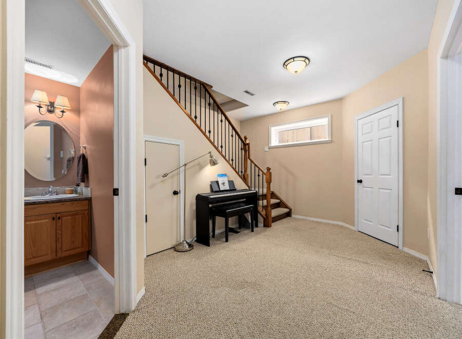 Discover this inviting home featuring a stylish piano area and a convenient powder room.