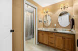 This beautiful bathroom features a double vanity with ample storage space, perfect for a busy household.