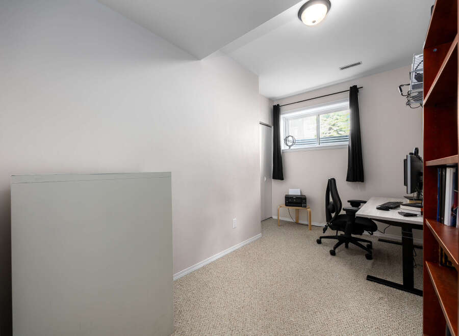 Discover the perfect home office setup in this well-lit space.