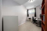 Discover the perfect home office setup in this well-lit space.
