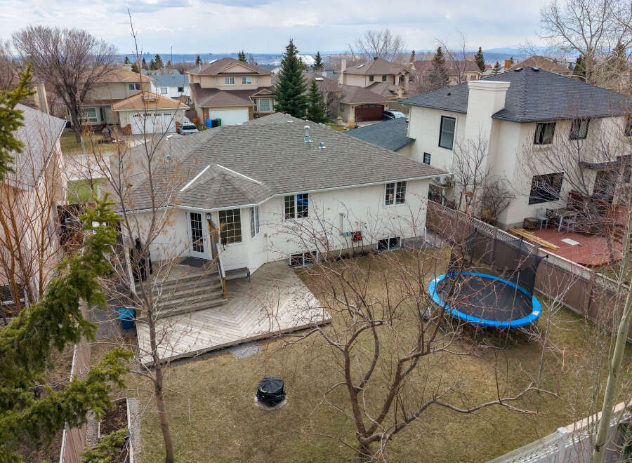 This stunning property boasts a spacious backyard with a trampoline, perfect for outdoor fun.