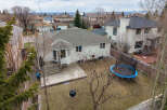 This stunning property boasts a spacious backyard with a trampoline, perfect for outdoor fun.