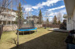 Enjoy outdoor living in this spacious backyard! Featuring a trampoline, a wooden deck, and a lush lawn, this property is perfect for families.