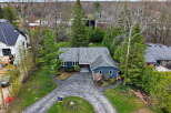 Discover this stunning property featuring a charming blue exterior and a beautifully landscaped yard.